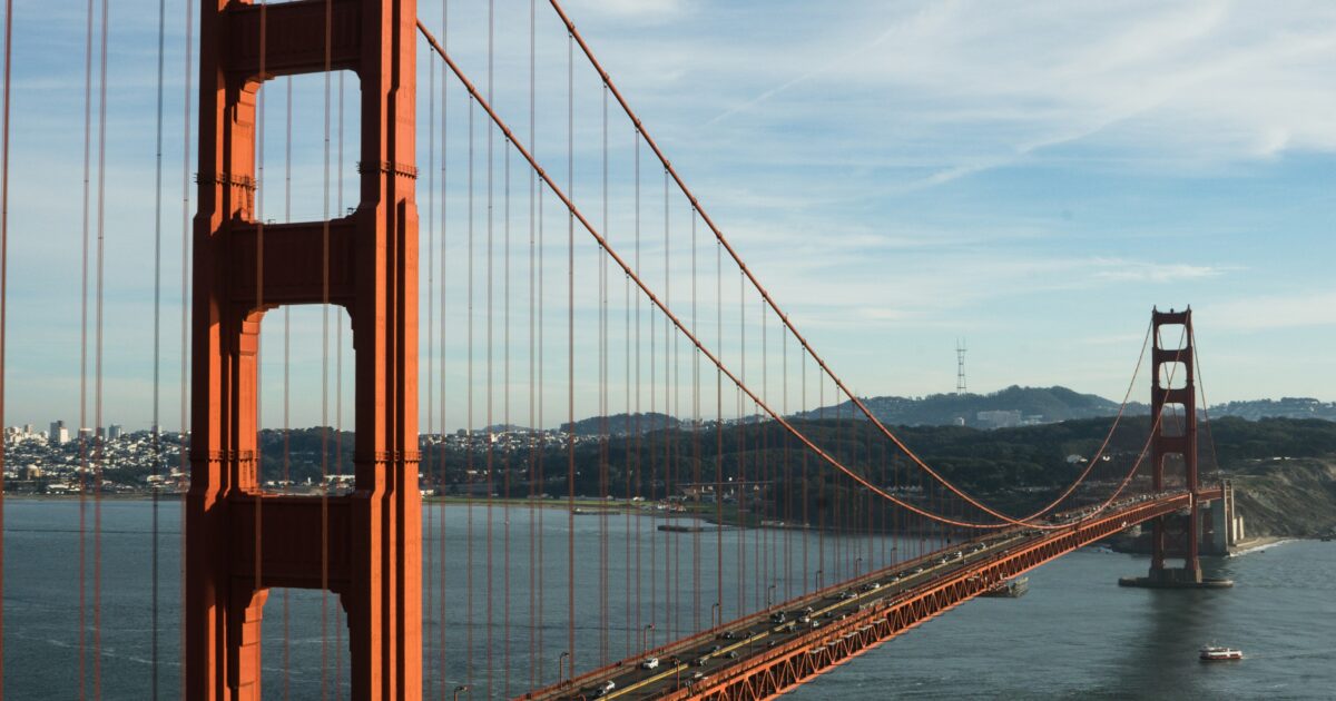The Golden Gate Bridge stretches over a body of water during the day