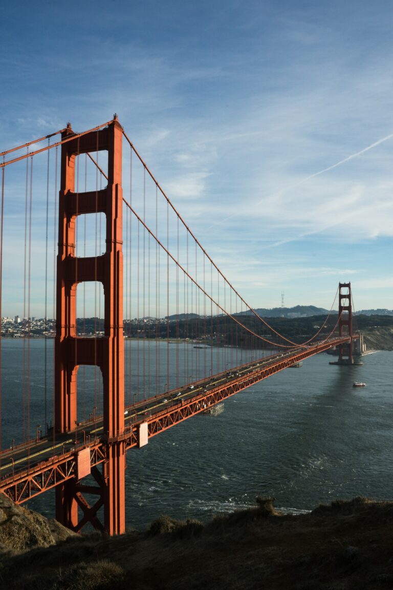 The Golden Gate Bridge stretches over a body of water during the day