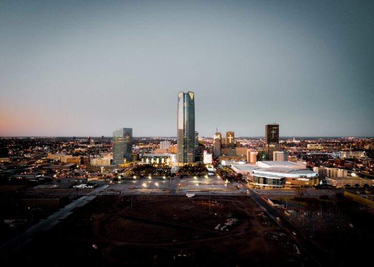 Oklahoma City buildings lit up as evening approaches