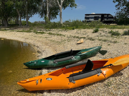 Kayaks in front of RV campsite for recreational hobby