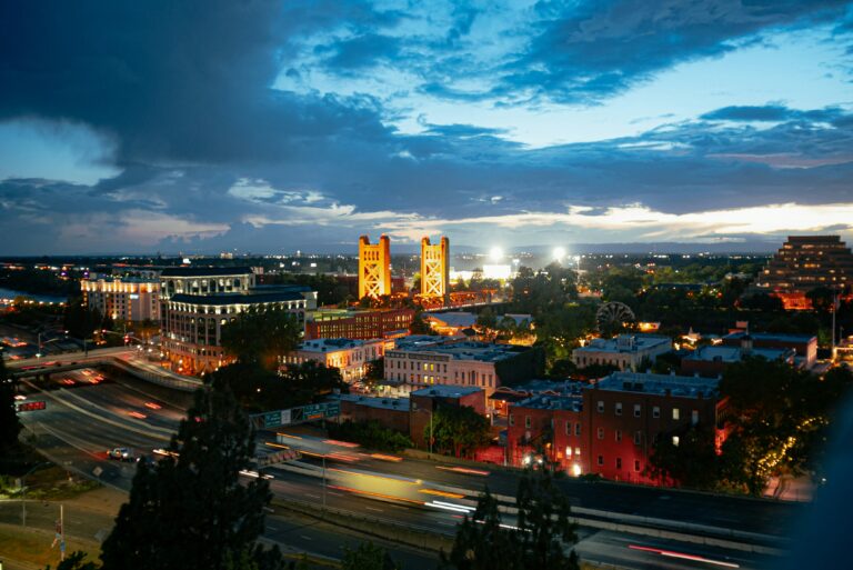 Downtown Sacramento lit up under an evening sky