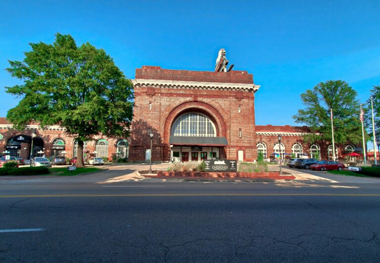 The red-brick Chattanooga Choo Choo Hotel with arched windows and surrounded by trees.