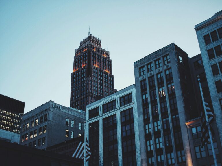 A US flag flies in front of city buildings in downtown Detroit