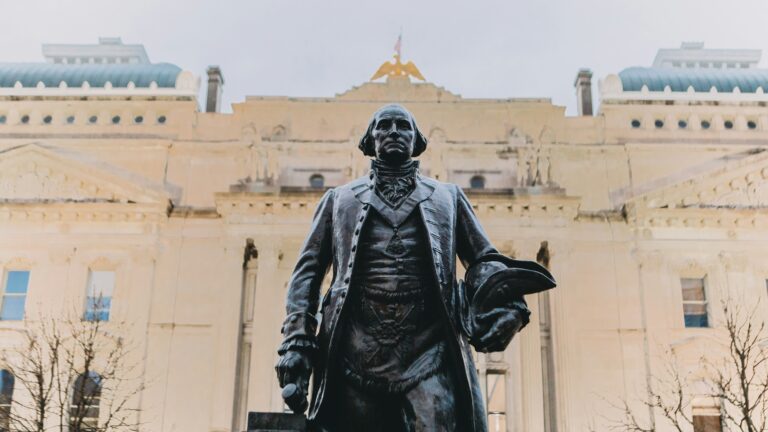 Statue of a man in front of the Indiana State House