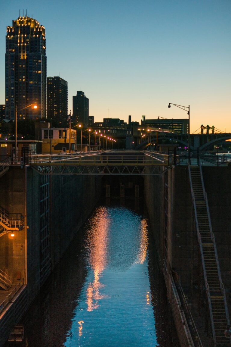 A river running past city buildings at dusk