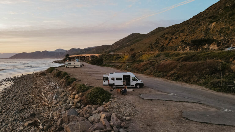 campers parked in california with pacific ocean in the background