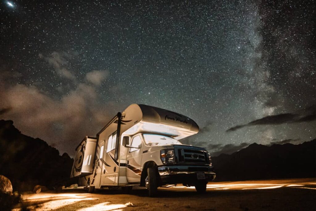 an RV at night, set up for celestial events