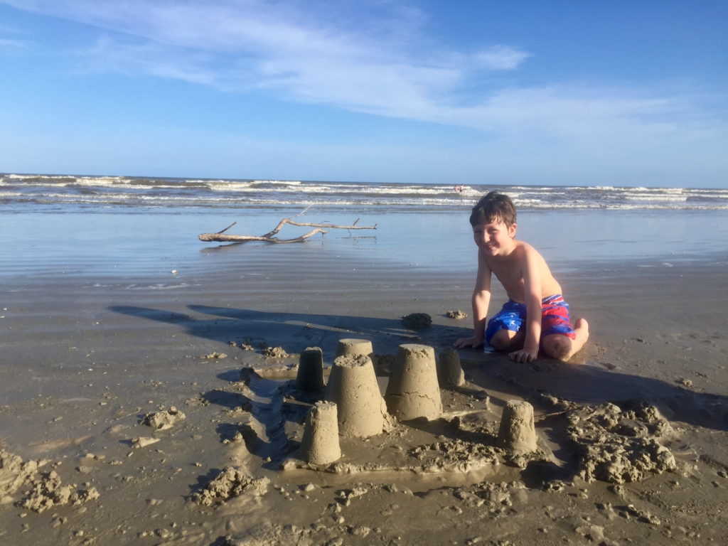 Boy building sandcastles in Galveston, Texas