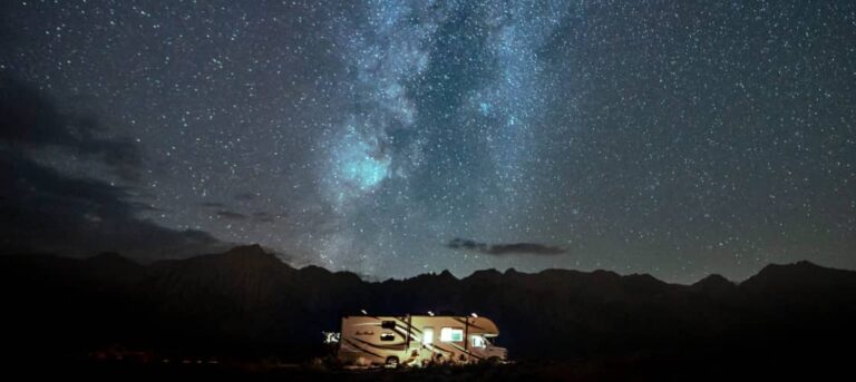 an RV set up for celestial events, under a star filled sky