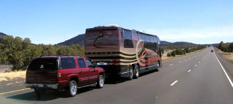 A Class A motorhome towing a car. Class A motorhomes may cause first time renters to have lots of questions