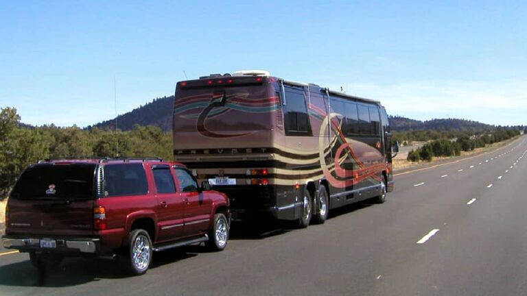 A Class A motorhome towing a car. Class A motorhomes may cause first time renters to have lots of questions