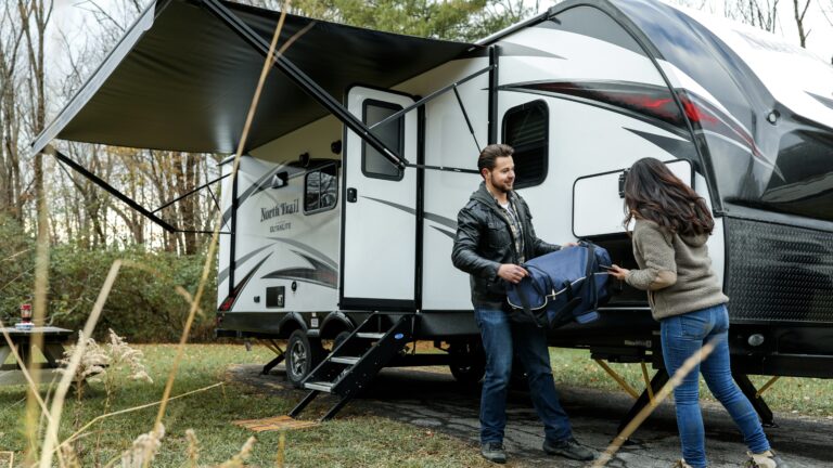 Couple packing an RV using their RV camping checklist