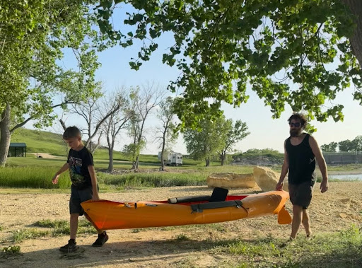 Father and son moving the Tucktec to the camper