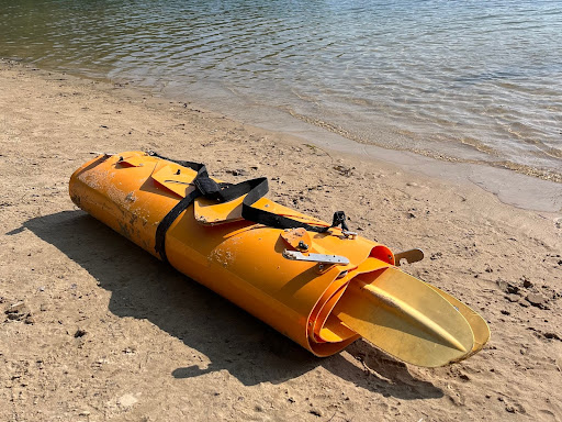 Tucktec kayak folded up on shoreline 