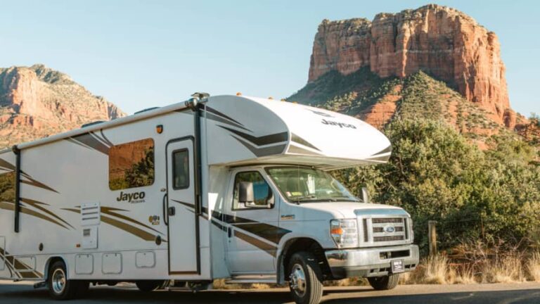 A class C RV parked in a scenic area on an RV road trip