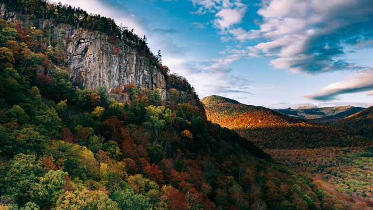 Stunning fall foliage lines the granite peaks of White Mountain National Forest in New Hampshire, a destination dupe for Acadia National Park