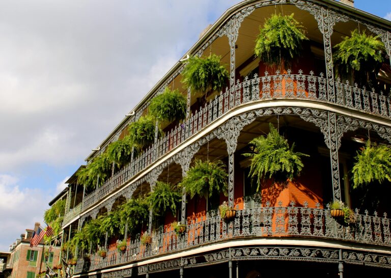French colonial architecture on a building overlooking New Orleans' French Quarter, an international destination dupe in the southeastern U.S.