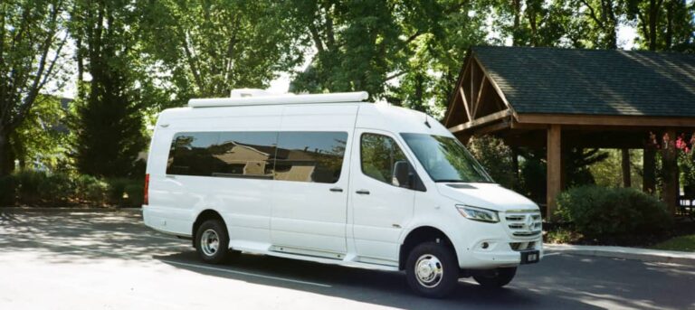 A campervan at a Pigeon Forge campground with a welcome center in the background