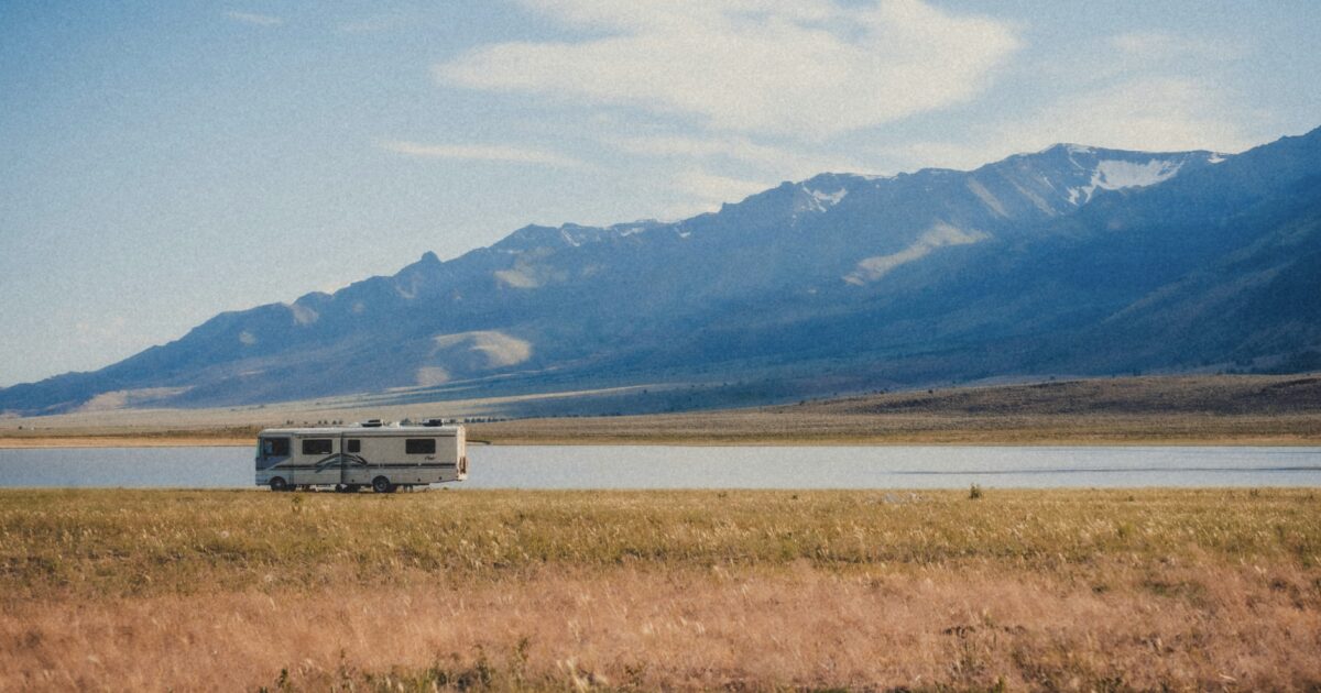 RV sitting next to a lake
