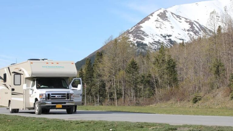 An RV driving down the road in Alaska
