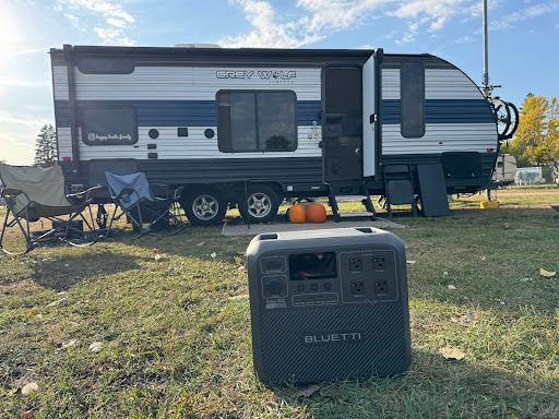 BLUETTI Elite 200 V2 in use in front of an RV travel trailer