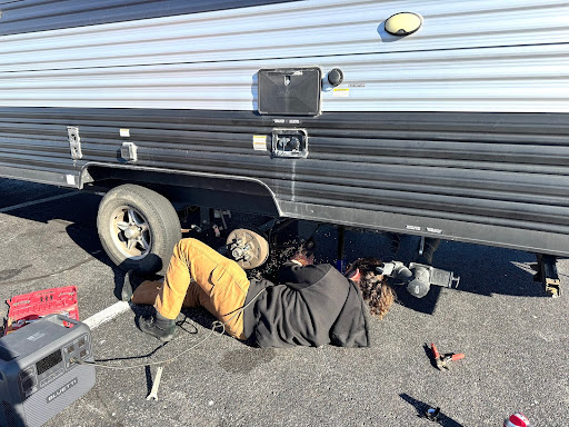 Man using the Bluetti Elite 200 v2 to power a grinder for camper repairs.