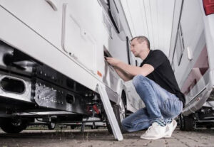 man performing maintenance on an RV