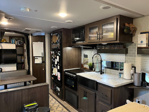 RV kitchen with RV fridge with food in travel trailer