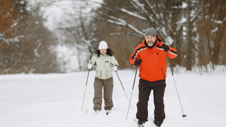 A happy couple cross-country skis in one of America's national parks