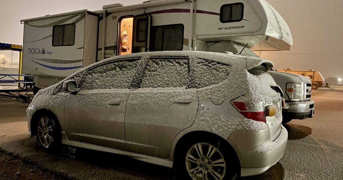 RV and car parked in the snow
