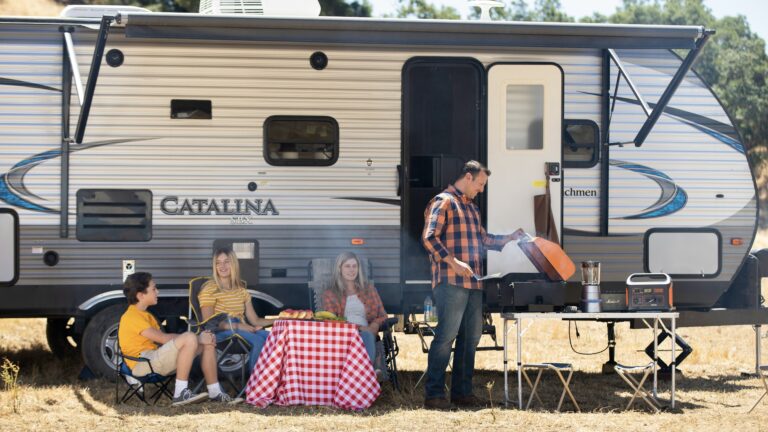 People hanging out outside of RV, RVing for the first time
