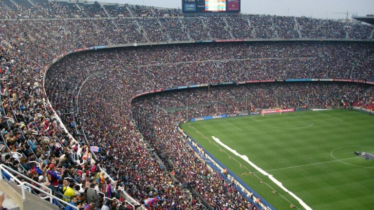A packed stadium of fans awaits a soccer match