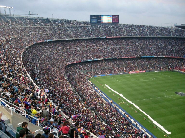 A packed stadium of fans awaits a soccer match