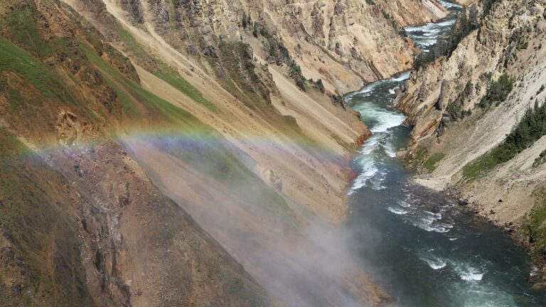 A rainbow shimmers over the river inside Grand Canyon National Park
