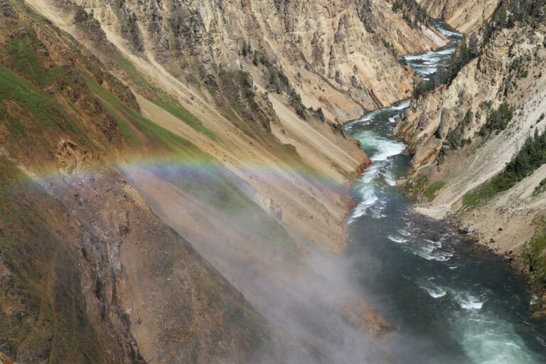 A rainbow shimmers over the river inside Grand Canyon National Park
